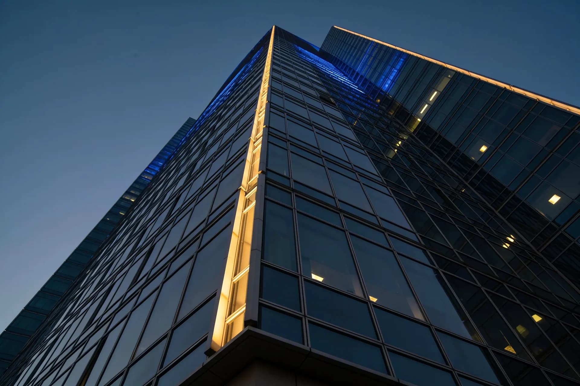 Corporate glass office tower at dusk
